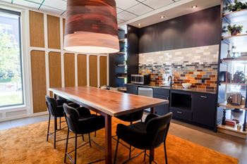 A modern kitchen with a dining table and chairs.
